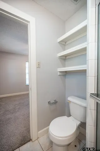 a white toilet sitting next to a bathroom sink