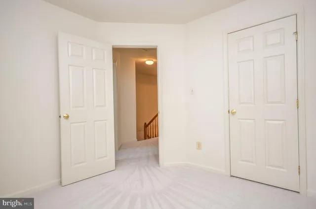 an empty room with closet and a bathroom