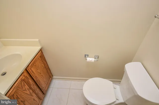 a bathroom with a toilet and a mirror