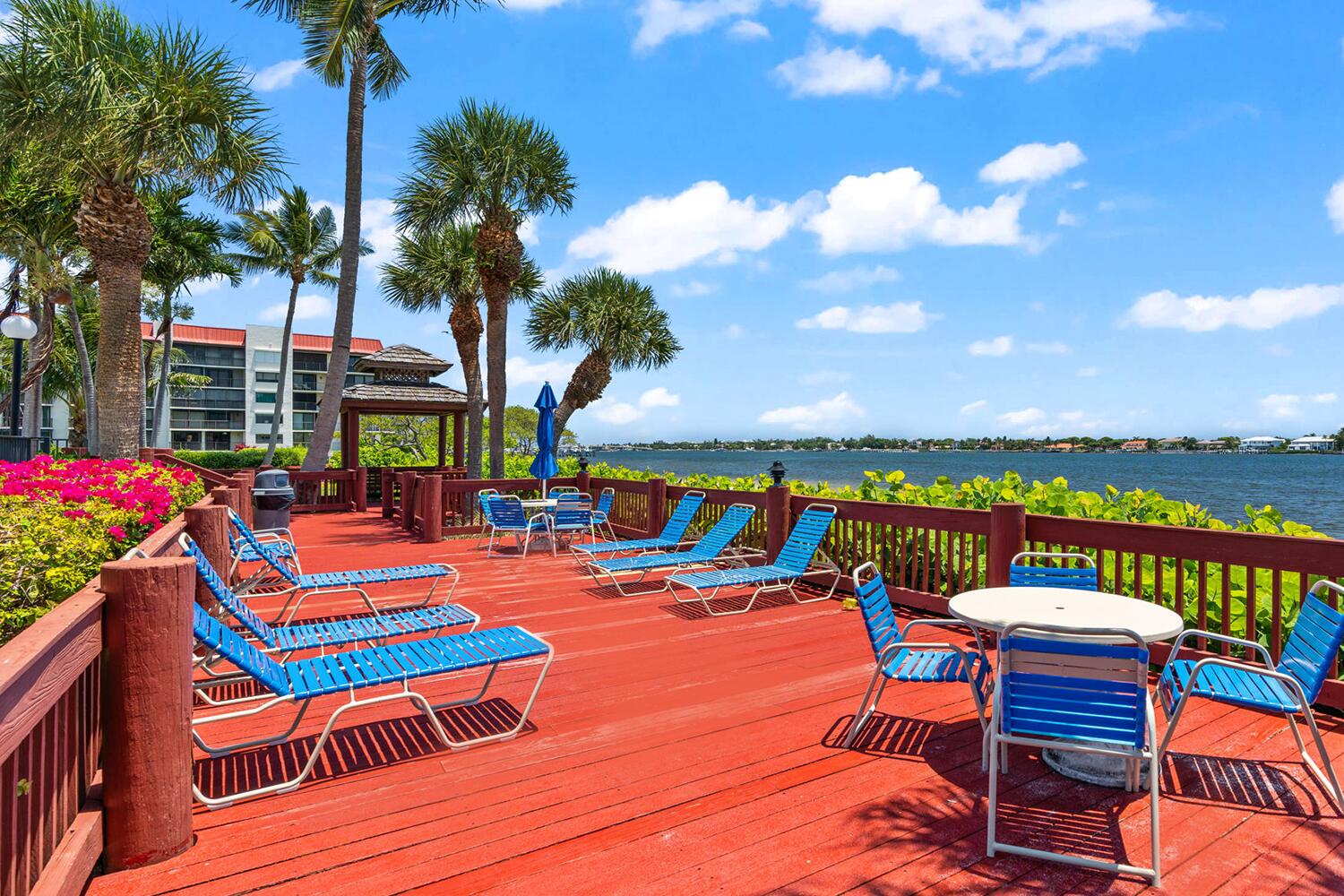 103 Half Moon Circle, Unit D2 Hypoluxo, FL 33462 - Photo 23 of 26 a wooden bench sitting in front of a building