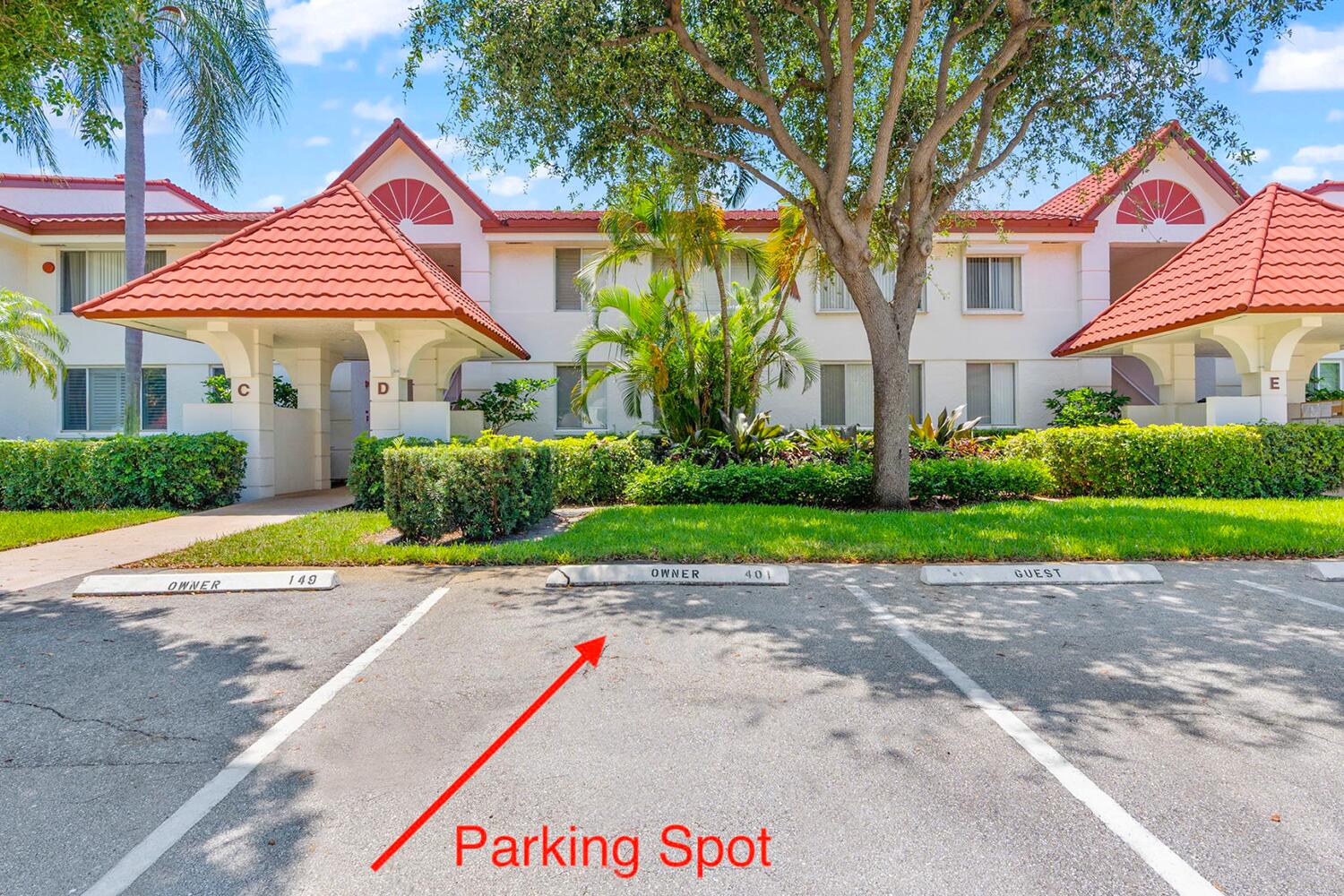 103 Half Moon Circle, Unit D2 Hypoluxo, FL 33462 - Photo 24 of 26 a view of a house with a yard and potted plants