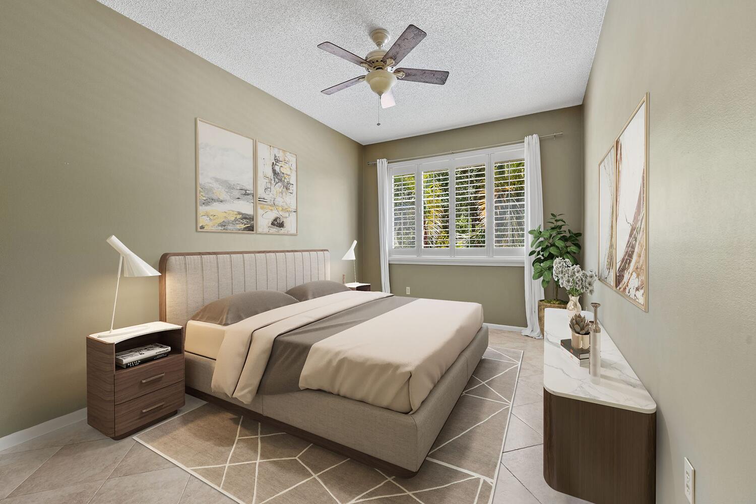 103 Half Moon Circle, Unit D2 Hypoluxo, FL 33462 - Photo 7 of 26 a bedroom with a bed and a chandelier