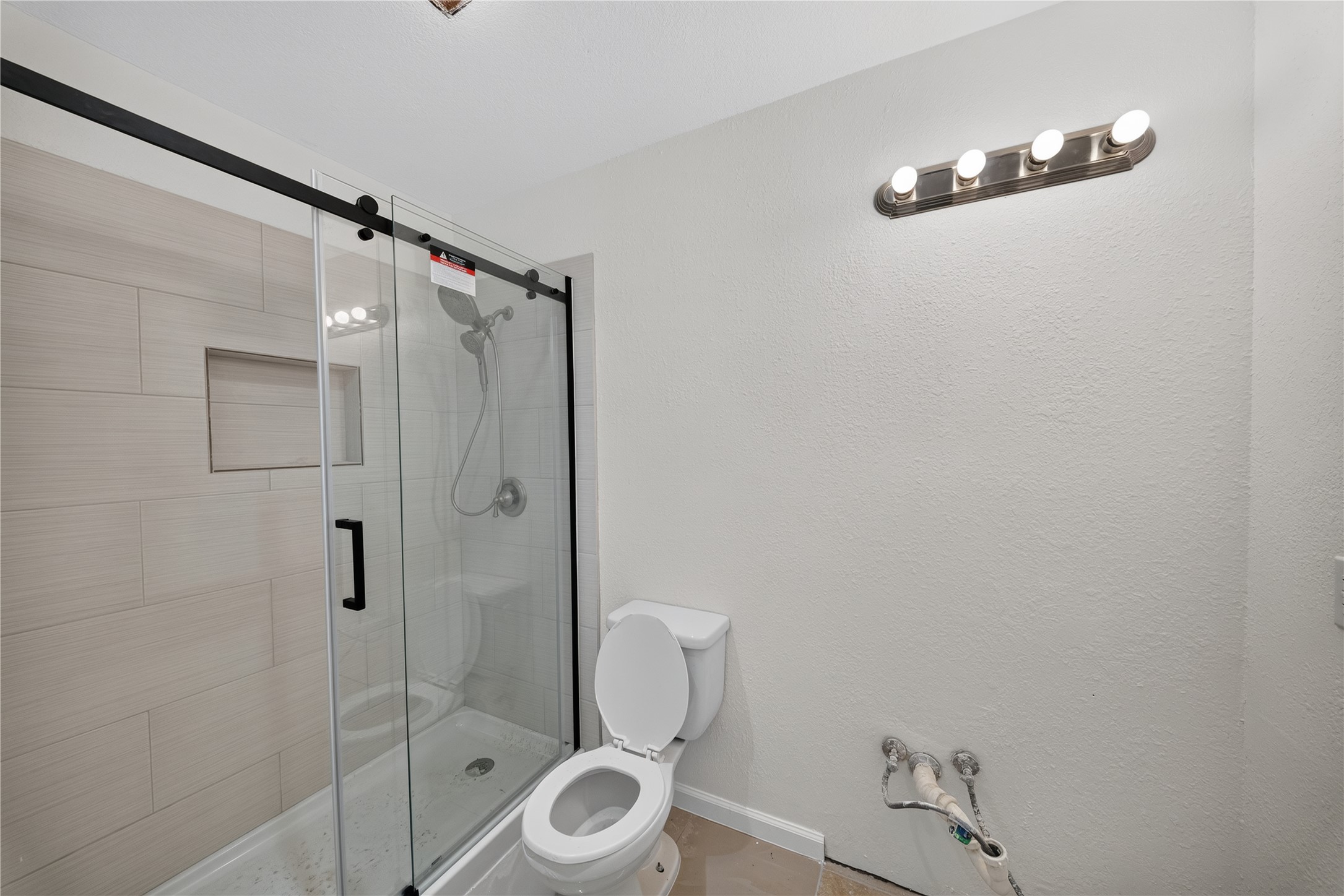 339 Fantail Loop, Unit B Austin, TX 78734 - Photo 17 of 21 a bathroom with a shower a toilet and a sink