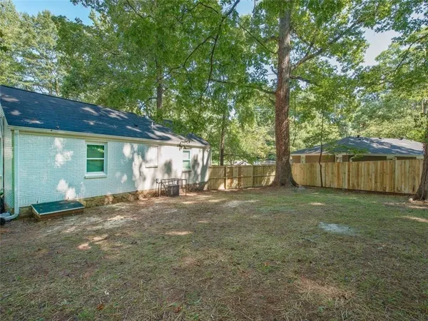 a view of a house with a yard and sitting area