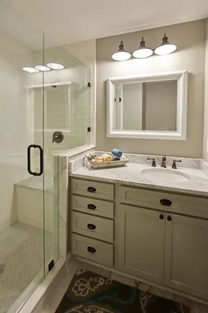 a bathroom with a double vanity sink mirror and shower