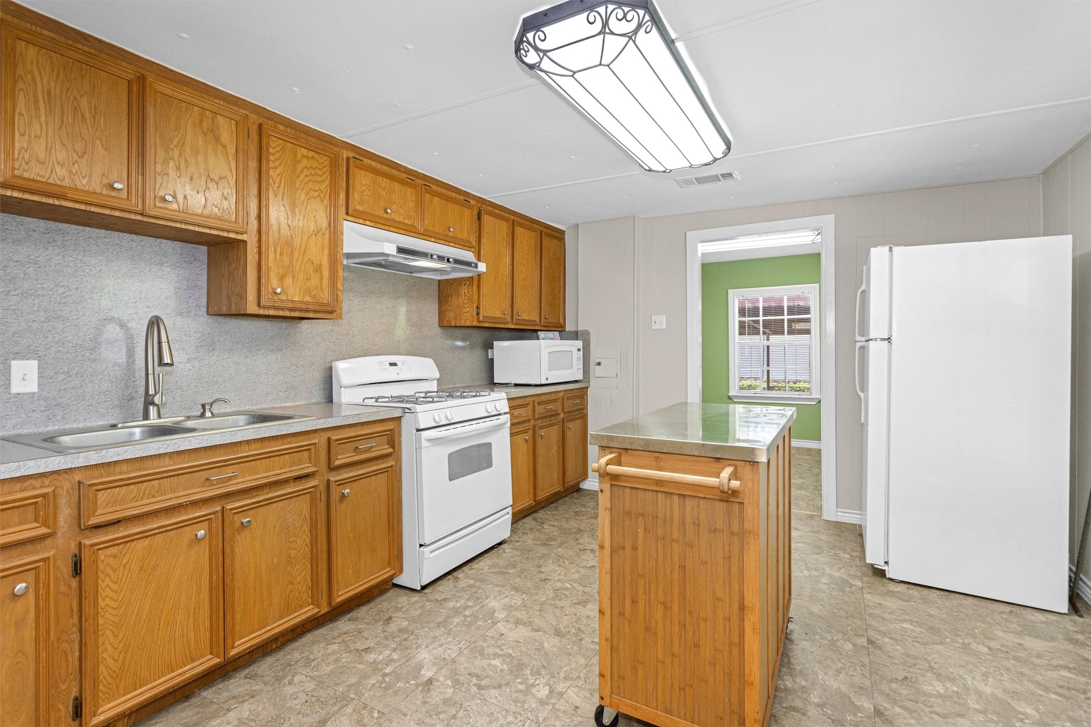 99 Main Street Huntsville, TX 77340 - Photo 12 of 47 The kitchen features wood cabinetry and an island for easy food prep.