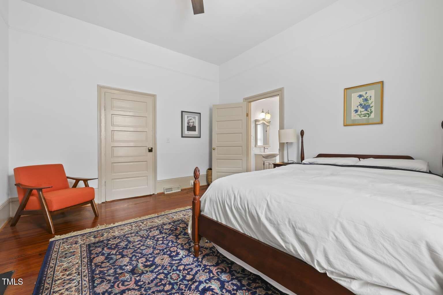 304 Linden Avenue Raleigh, NC 27601 - Photo 14 of 33 a bed room with a bed and a chair