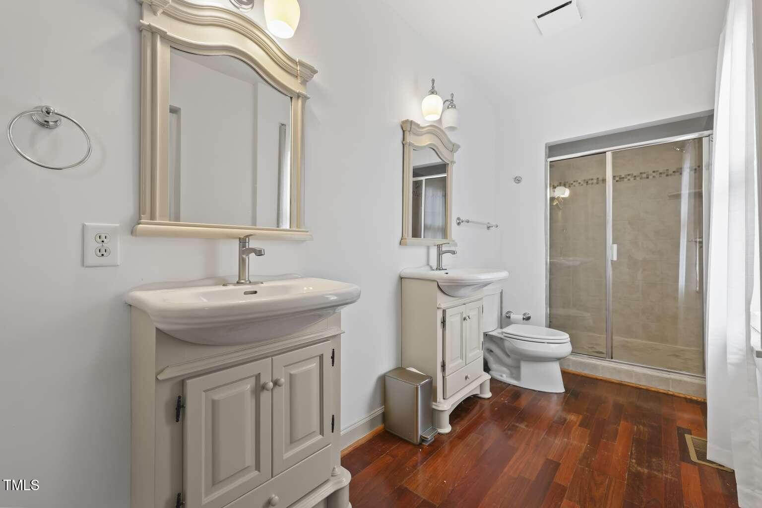 304 Linden Avenue Raleigh, NC 27601 - Photo 15 of 33 a bathroom with a sink a toilet and a mirror