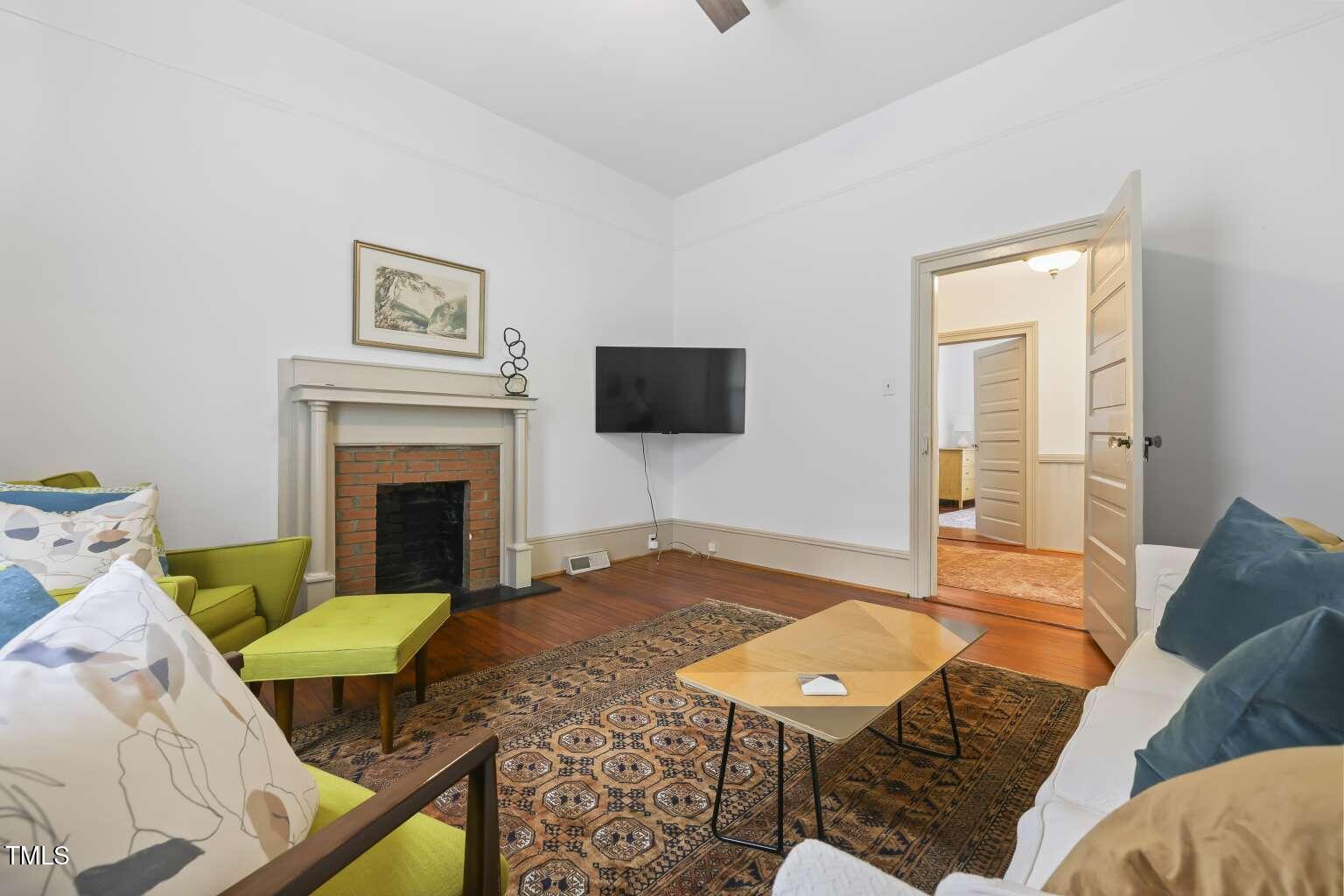 304 Linden Avenue Raleigh, NC 27601 - Photo 20 of 33 a living room with a couch and a flat screen tv