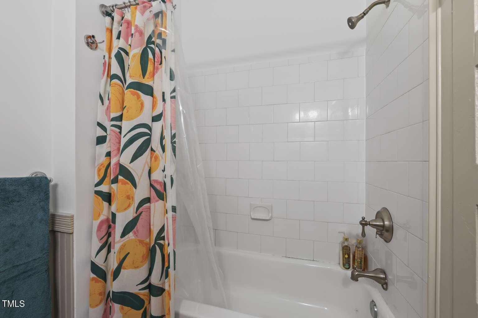 304 Linden Avenue Raleigh, NC 27601 - Photo 22 of 33 a bathroom with a bathtub and a shower curtain