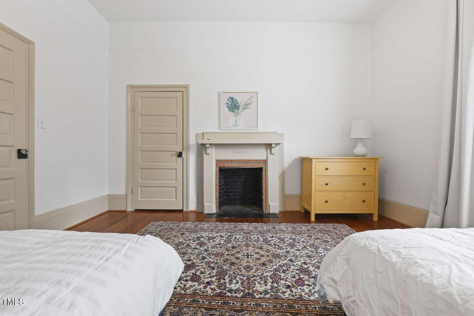304 Linden Avenue Raleigh, NC 27601 - Photo 26 of 33 a bedroom with a bed and cabinets