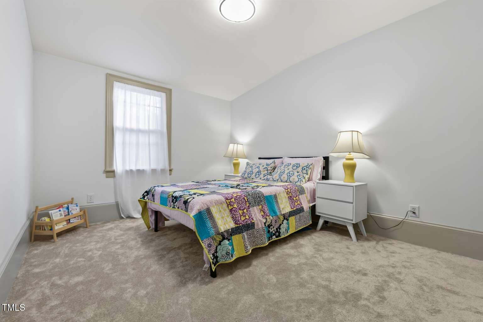 304 Linden Avenue Raleigh, NC 27601 - Photo 27 of 33 a bedroom with a bed and a window