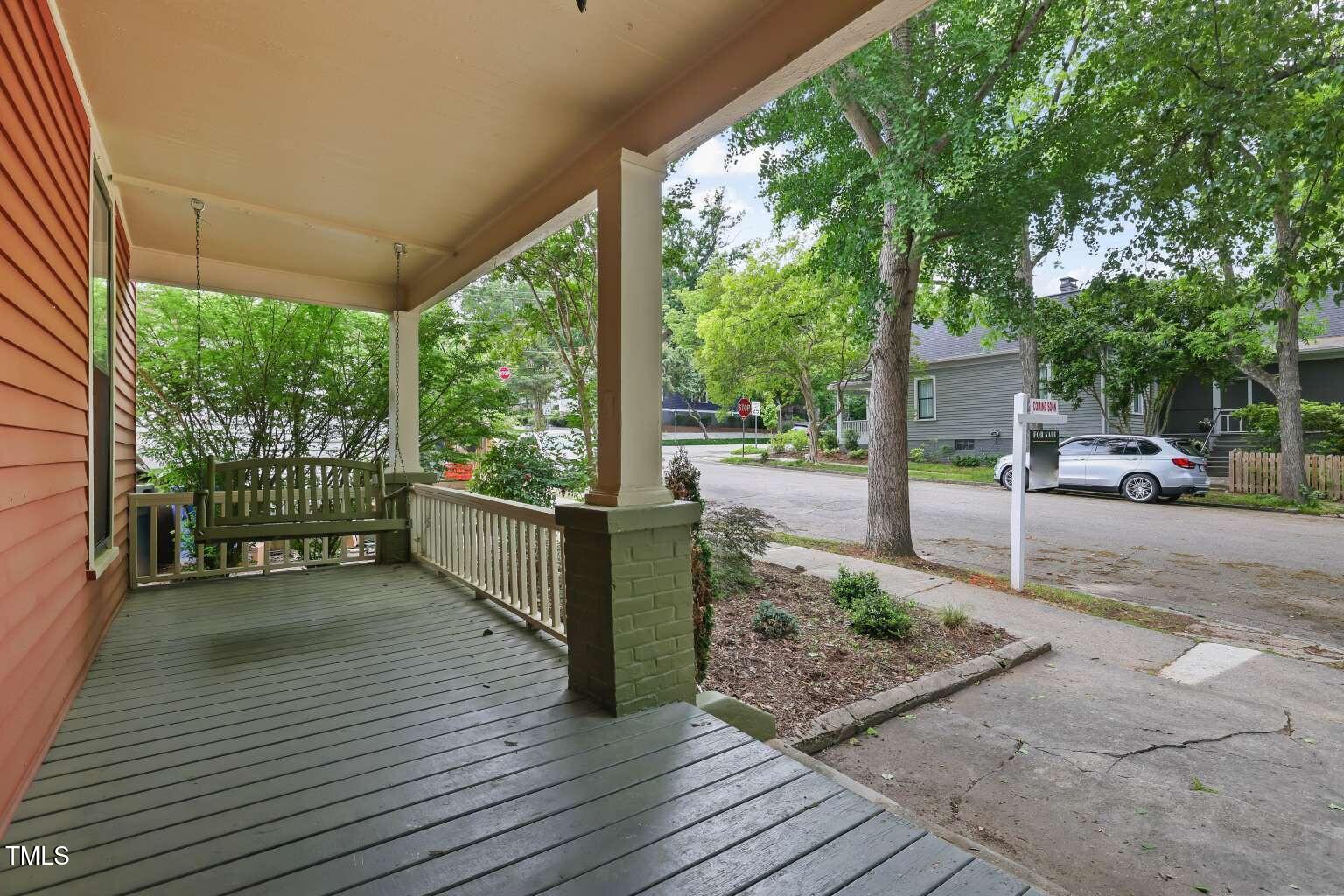 304 Linden Avenue Raleigh, NC 27601 - Photo 3 of 33 a view of a porch with wooden floor and fence