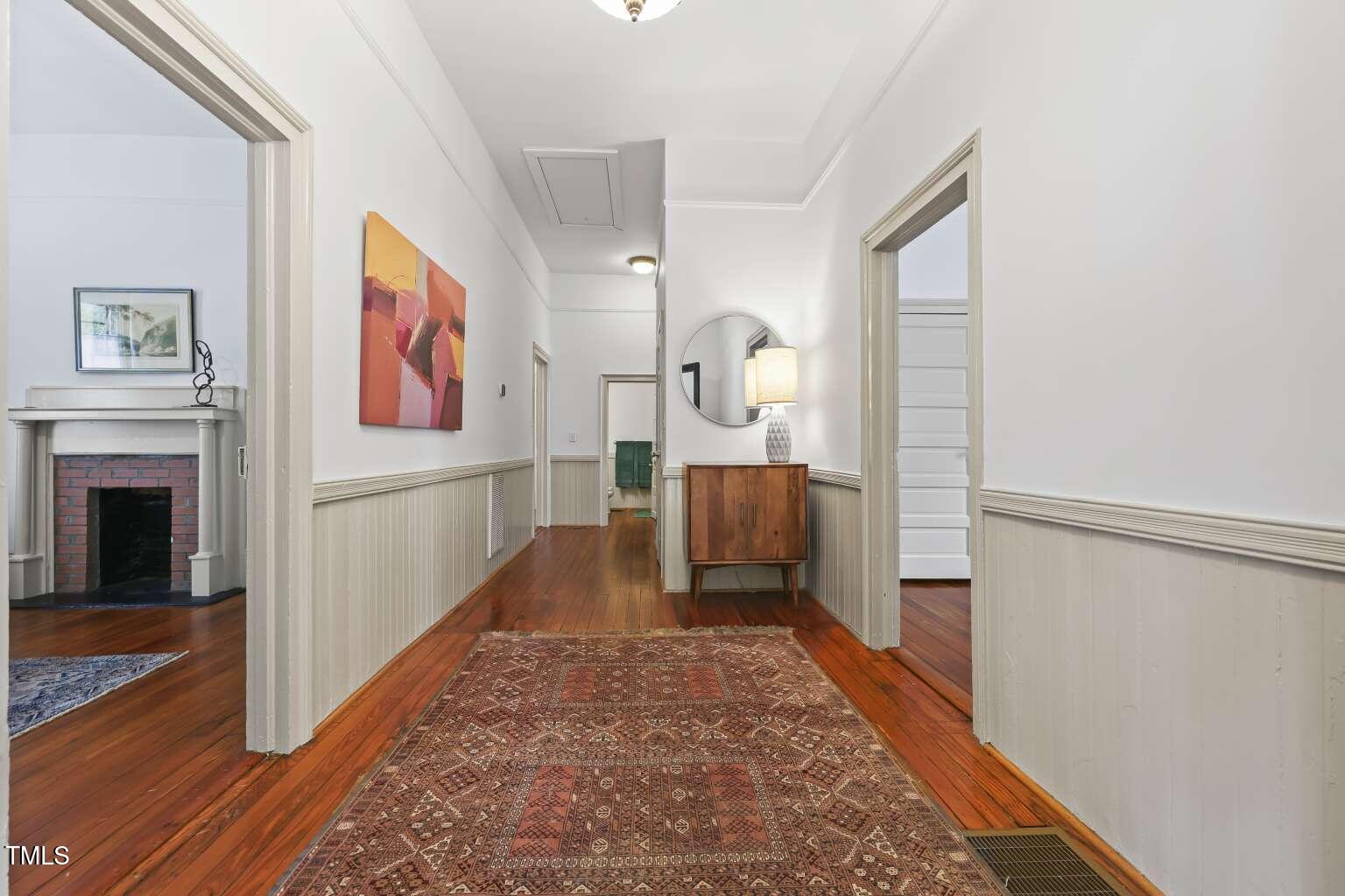 304 Linden Avenue Raleigh, NC 27601 - Photo 5 of 33 a view of a hallway with wooden floor and staircase