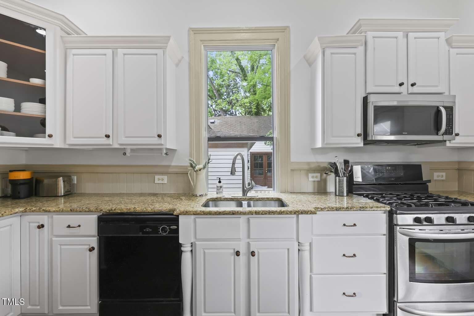 304 Linden Avenue Raleigh, NC 27601 - Photo 8 of 33 a kitchen with granite countertop cabinets stainless steel appliances and a sink