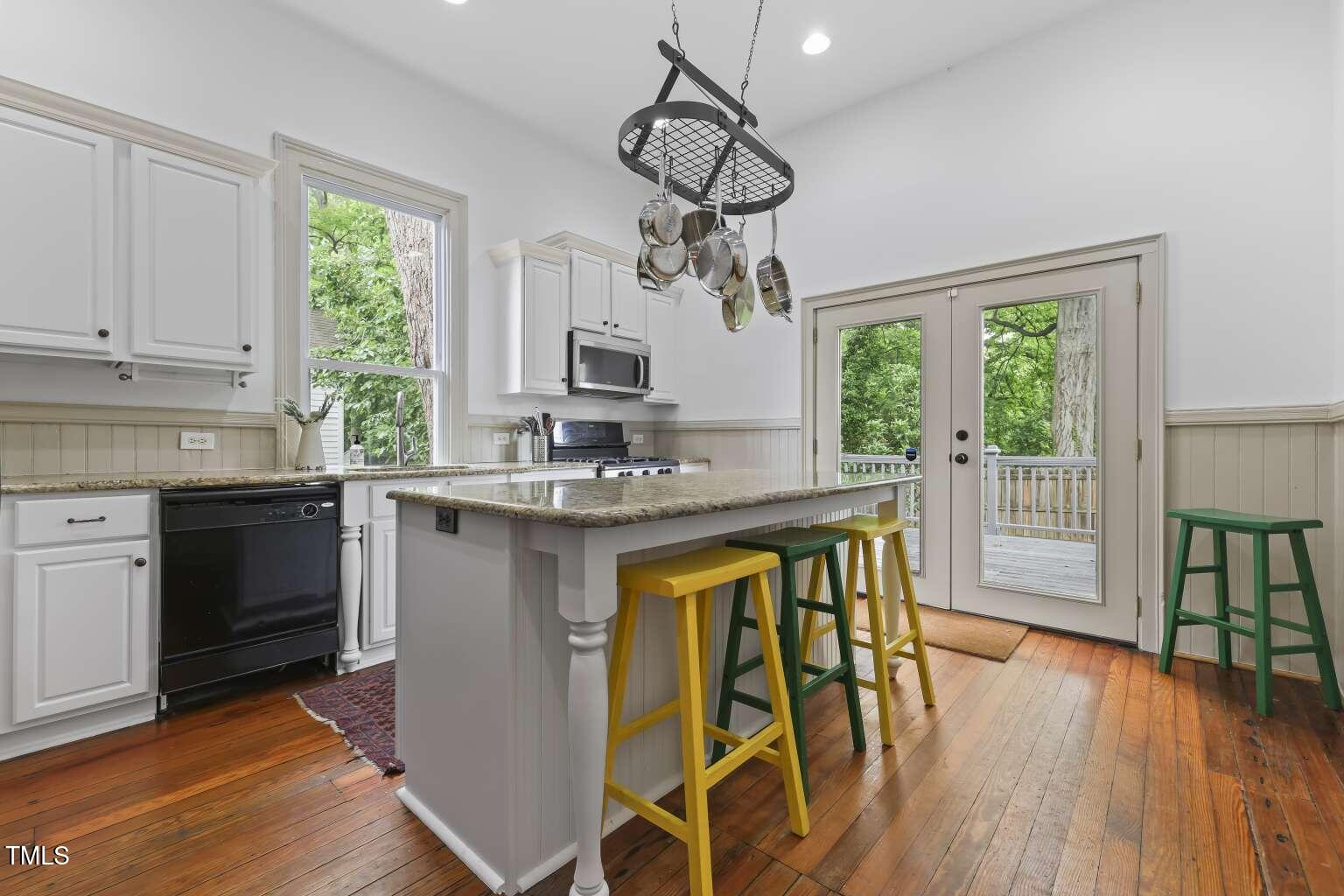 304 Linden Avenue Raleigh, NC 27601 - Photo 9 of 33 a kitchen with stainless steel appliances granite countertop wooden floors and sink