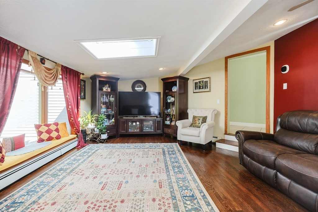 2 Rhodes Avenue Sharon, MA 02067 - Photo 17 of 42 a living room with furniture and a flat screen tv