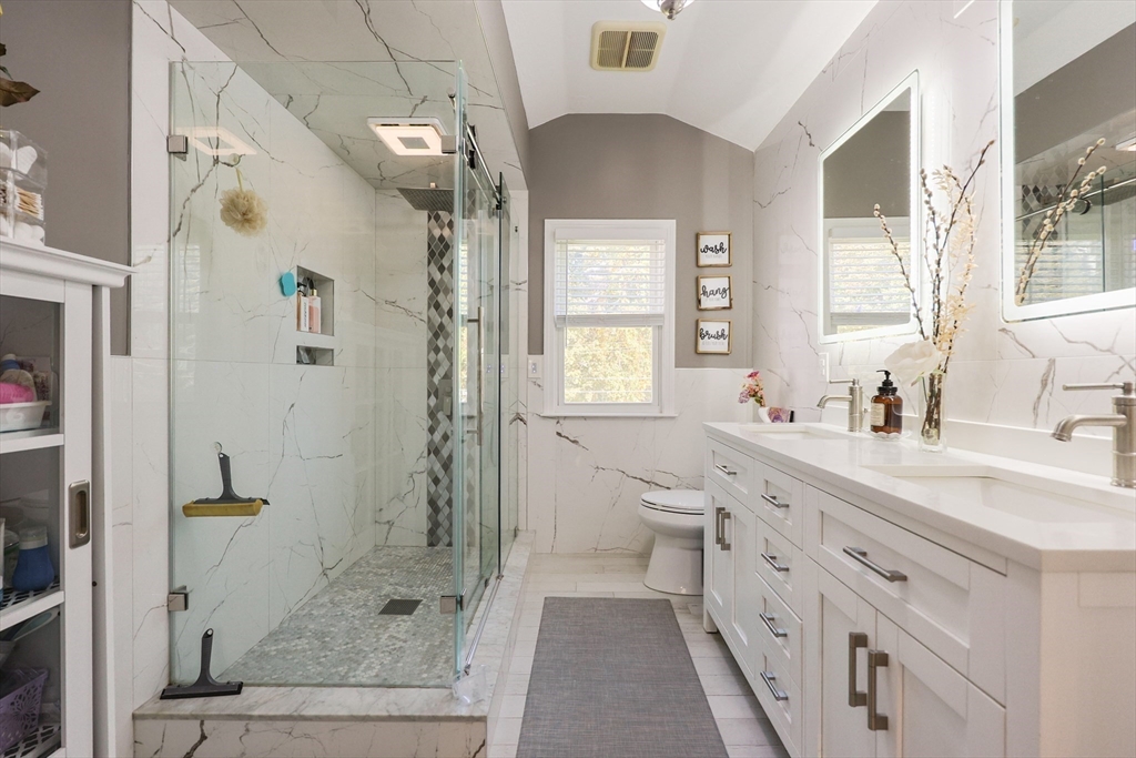 2 Rhodes Avenue Sharon, MA 02067 - Photo 25 of 42 a spacious bathroom with a double vanity sink toilet mirror and next to a window
