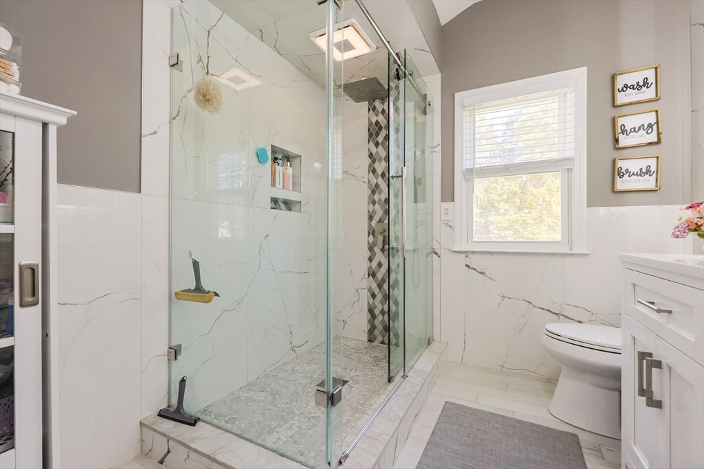 2 Rhodes Avenue Sharon, MA 02067 - Photo 26 of 42 a bathroom with a granite countertop shower a toilet and a sink