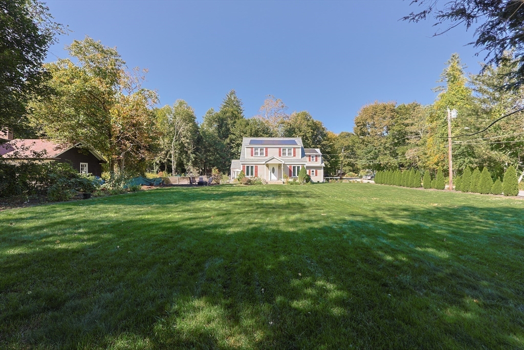 2 Rhodes Avenue Sharon, MA 02067 - Photo 39 of 42 a backyard of a house with lots of green space and fountain