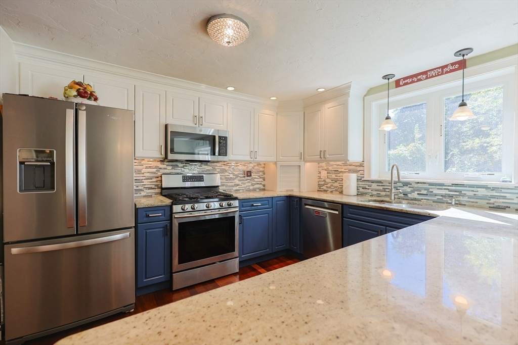 2 Rhodes Avenue Sharon, MA 02067 - Photo 8 of 42 a kitchen with granite countertop a refrigerator stove and sink