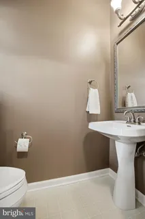 a bathroom with a sink toilet and mirror