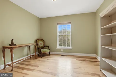 a view of a livingroom with workspace and a window