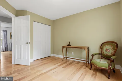 a view of room with wooden floor lounge chair and windows