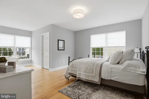 a bedroom with a bed and glass window