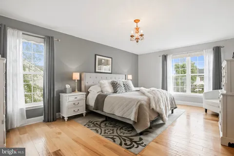 a spacious bedroom with a bed and a window