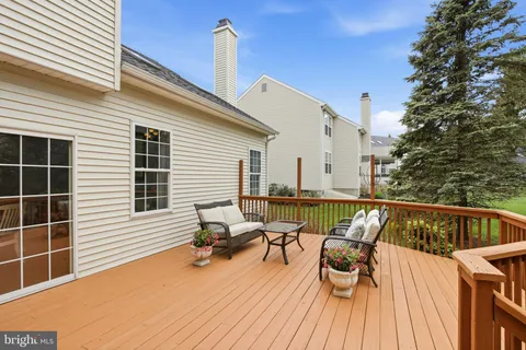 a balcony with wooden floor and furniture