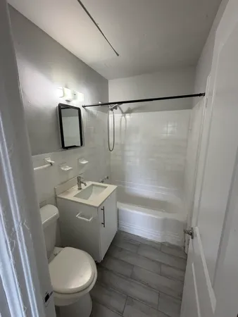 a bathroom with a toilet a sink and bathtub