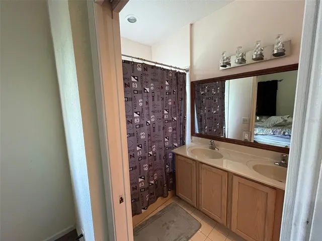 a bathroom with a sink a mirror and a shower