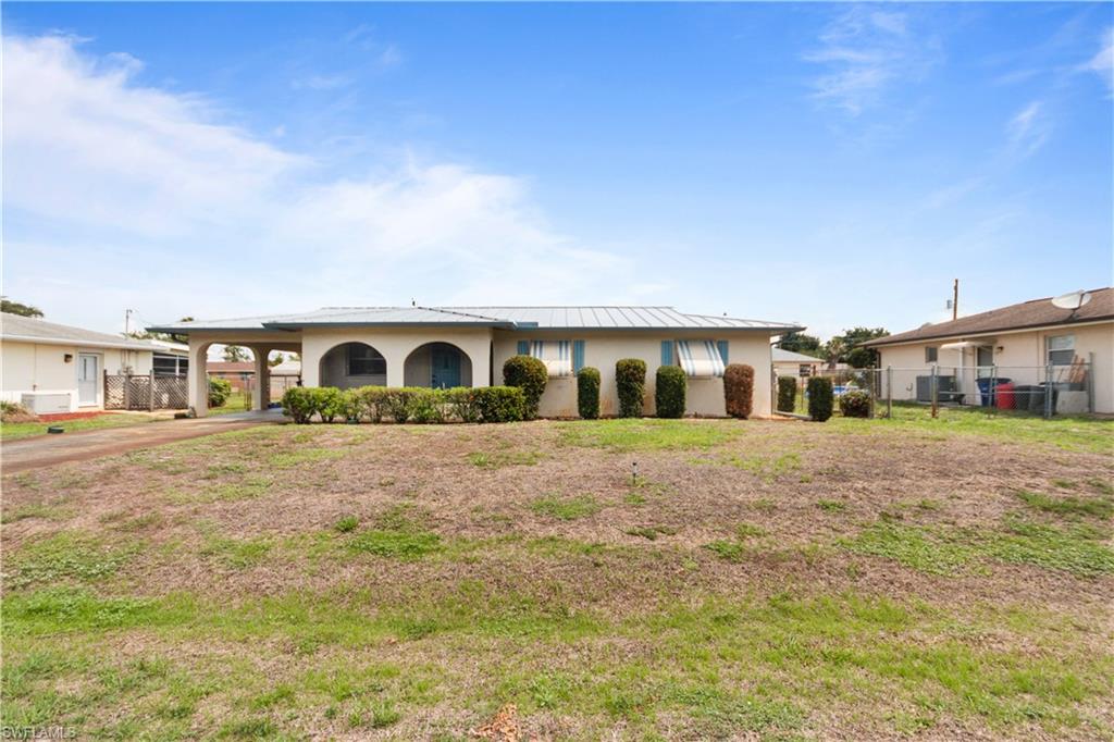 7225 Jasmine Road Fort Myers, FL 33967 - Photo 1 of 24 a front view of house with yard