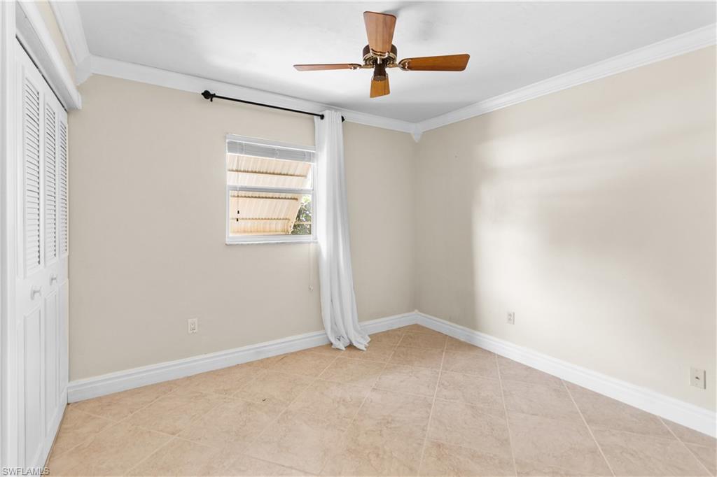 7225 Jasmine Road Fort Myers, FL 33967 - Photo 11 of 24 an empty room with windows and chandelier fan
