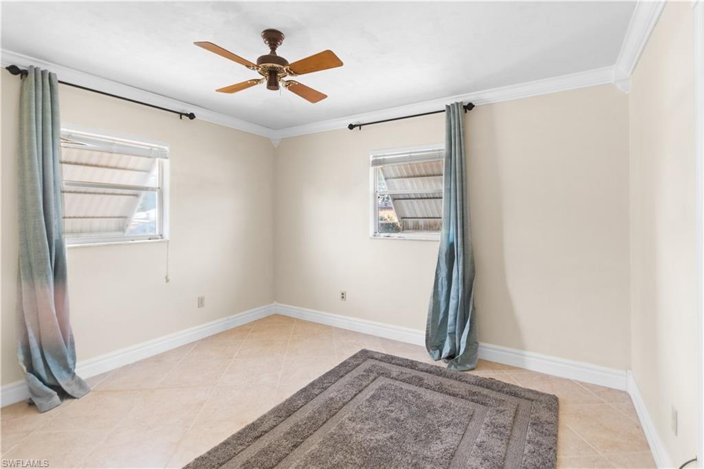 7225 Jasmine Road Fort Myers, FL 33967 - Photo 12 of 24 an empty room with windows and fan