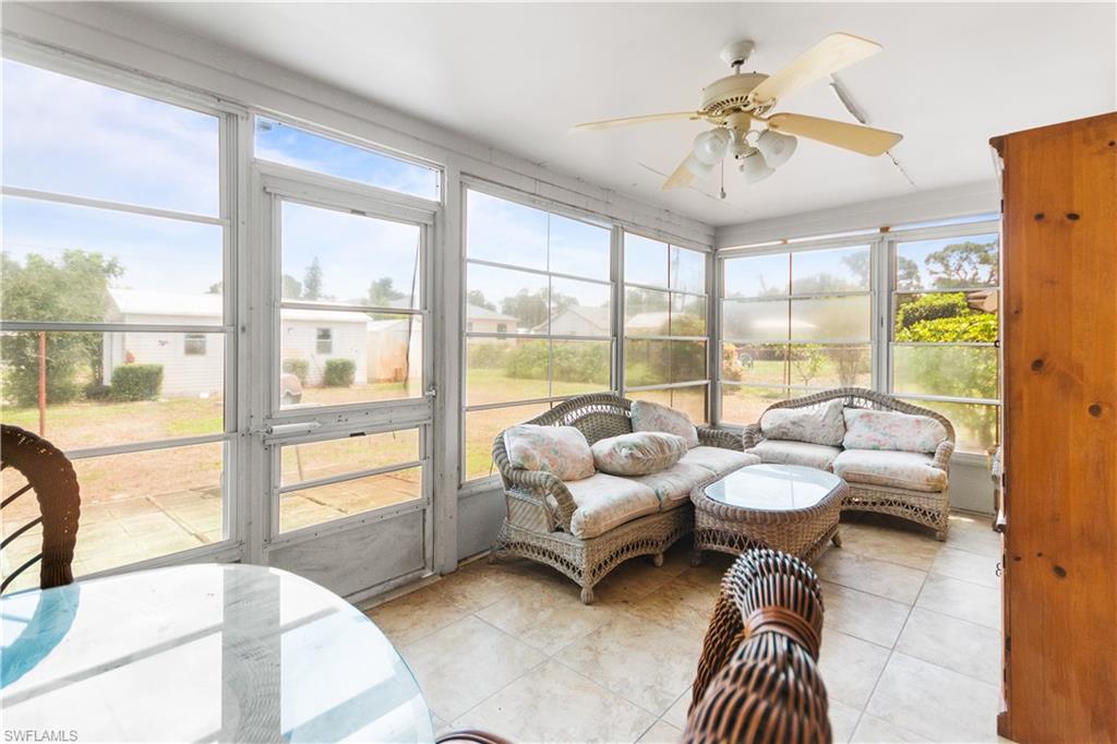 7225 Jasmine Road Fort Myers, FL 33967 - Photo 18 of 24 a living room with furniture and a large window with outer view