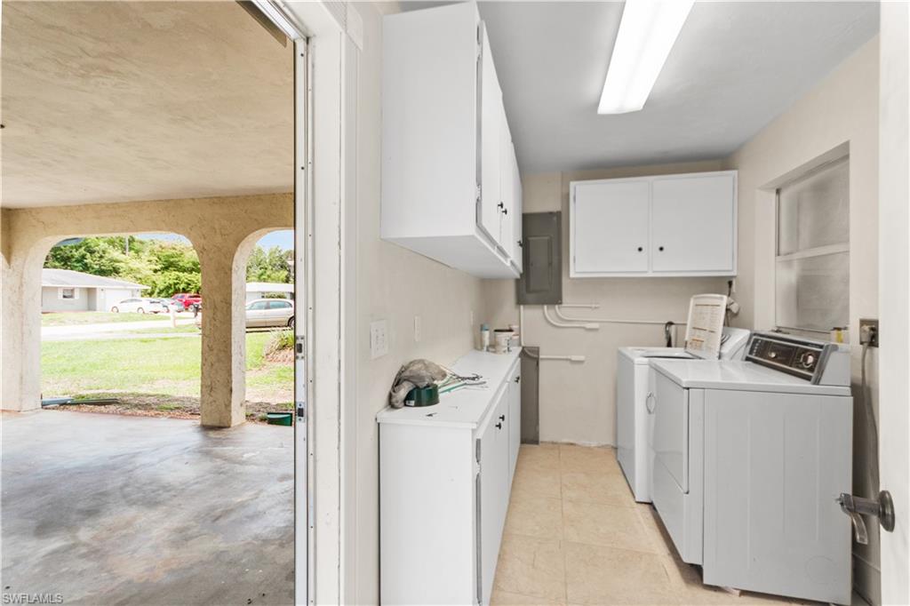 7225 Jasmine Road Fort Myers, FL 33967 - Photo 19 of 24 a kitchen with a refrigerator a stove a washer dryer and white cabinets
