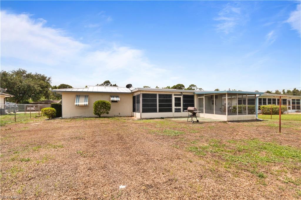 7225 Jasmine Road Fort Myers, FL 33967 - Photo 22 of 24 a front view of a house with a yard and garage