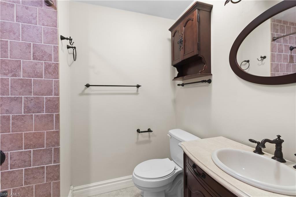 7225 Jasmine Road Fort Myers, FL 33967 - Photo 9 of 24 a bathroom with a sink a toilet and a mirror