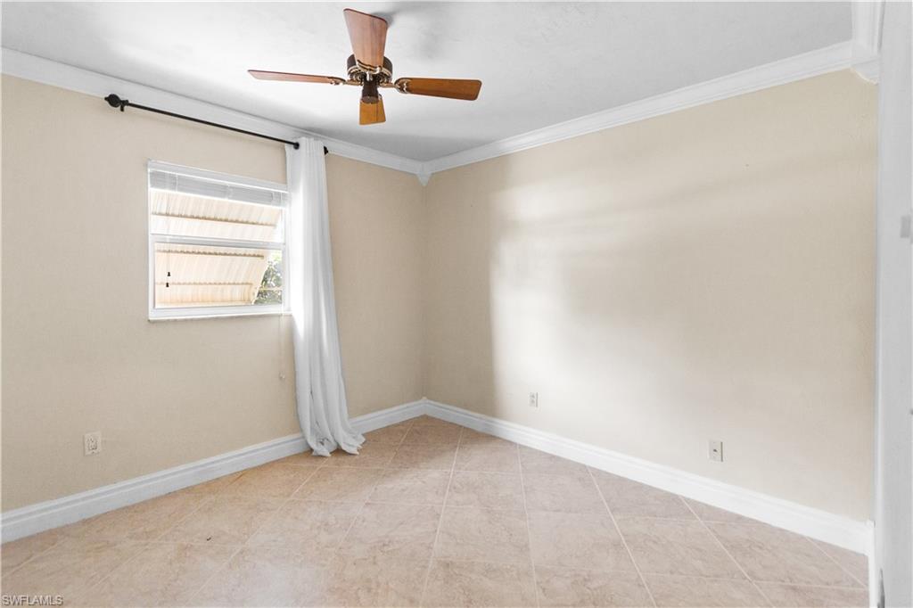 7225 Jasmine Road Fort Myers, FL 33967 - Photo 10 of 24 an empty room with windows and fan