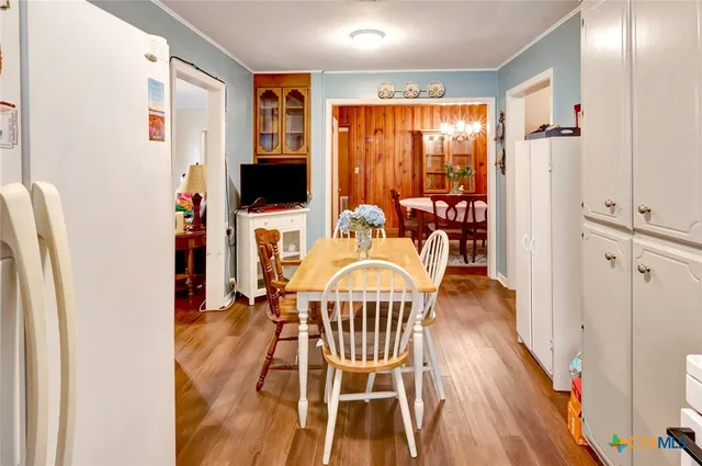 a dining room with furniture and wooden floor