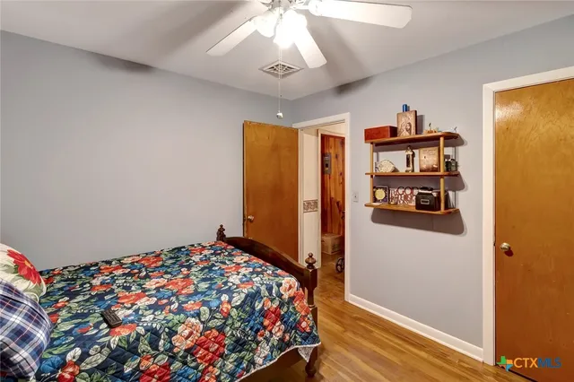 a bedroom with bed and a chandelier
