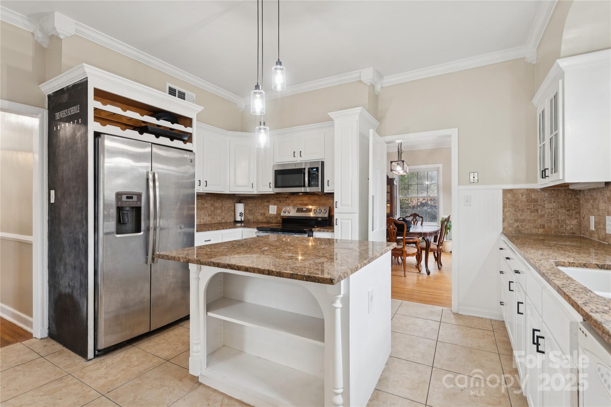 514 West Barr Street Lancaster, SC 29720 - Photo 13 of 36 a kitchen with granite countertop a refrigerator and a stove top oven