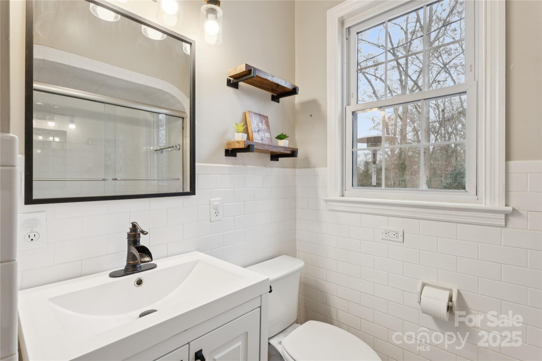 514 West Barr Street Lancaster, SC 29720 - Photo 18 of 36 a bathroom with a toilet a sink and mirror
