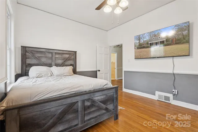 a bedroom with a bed and a night stand