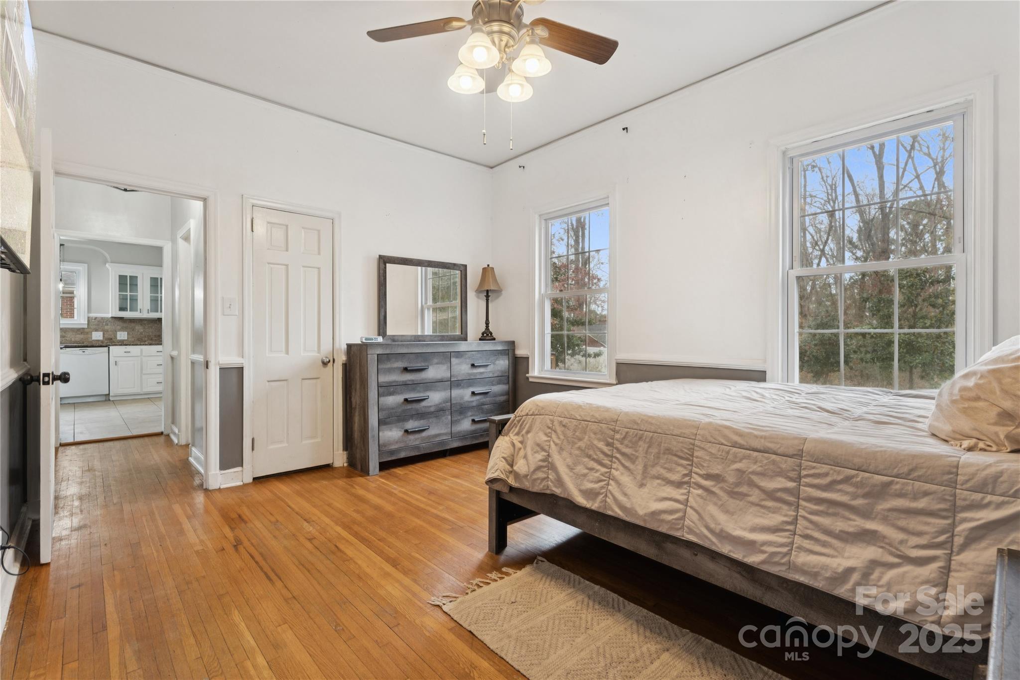 514 West Barr Street Lancaster, SC 29720 - Photo 22 of 36 a bedroom with a large bed and a chandelier