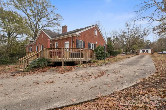 a view of a house with a yard covered in snow