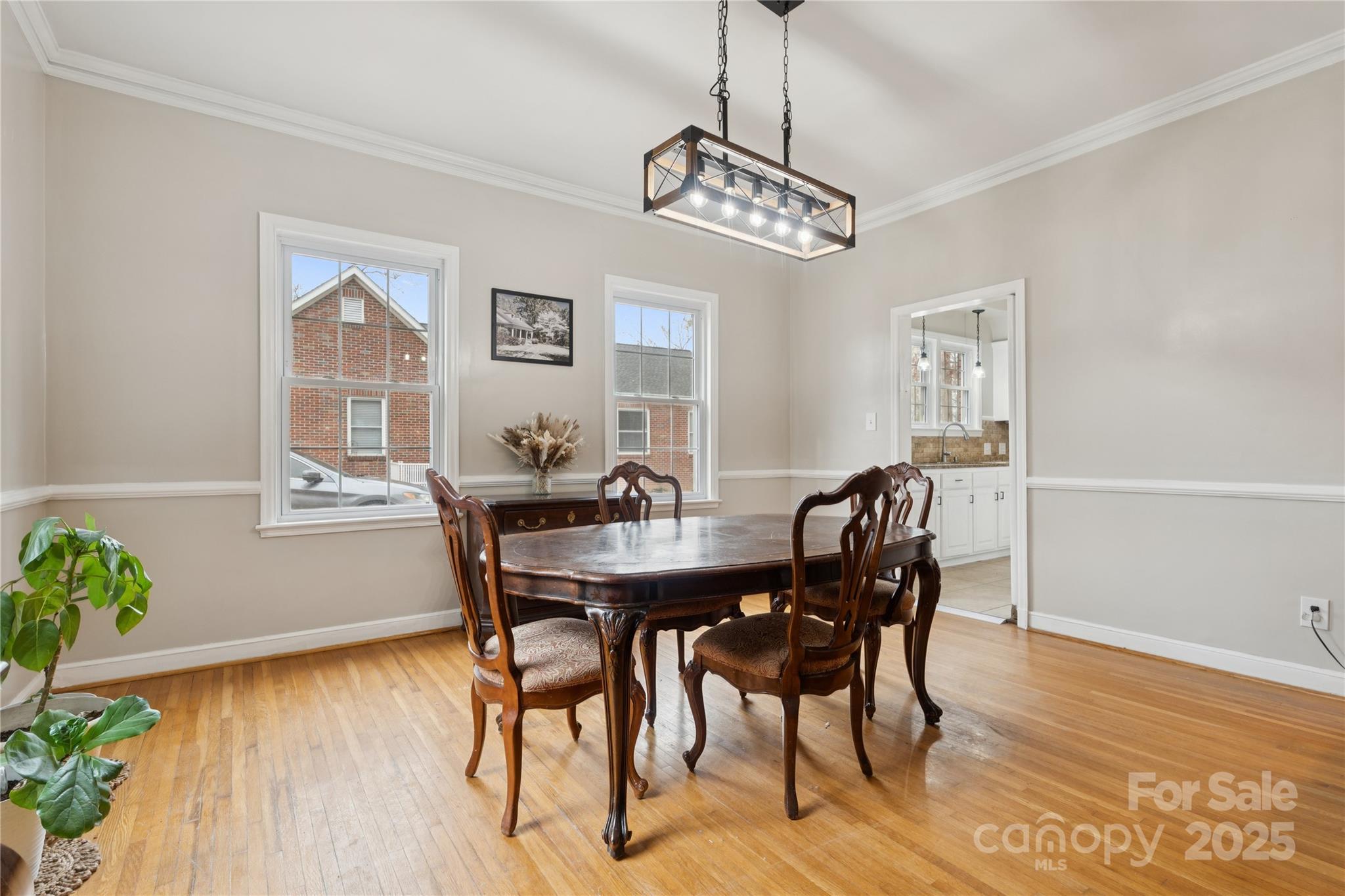 514 West Barr Street Lancaster, SC 29720 - Photo 10 of 36 a view of a dining room with furniture wooden floor and chandelier