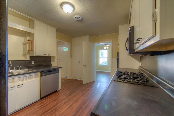 a kitchen with a sink and a stove top oven